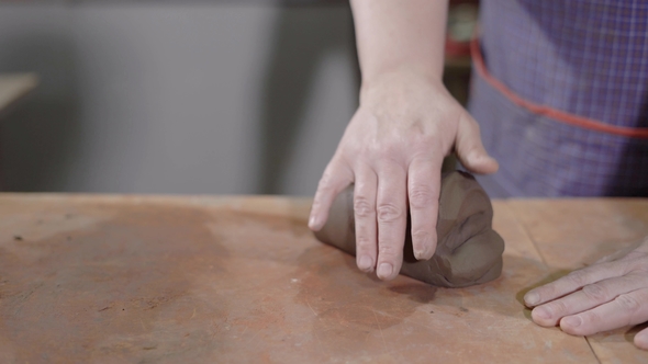 Master Rolling Out Clay. Crop Strong Hands of Talented Potter Wedging for Creating Masterpiece on