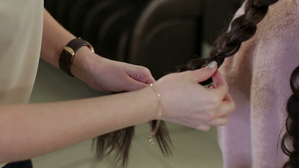 Hairdresser Making Big Braid for Client in Salon.