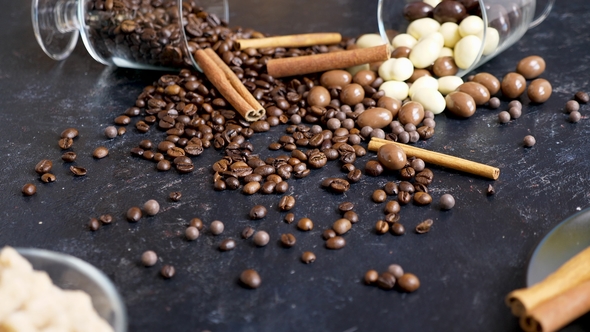 Two Overturned Glasses with Peanuts in Chocolate and Coffee Beans