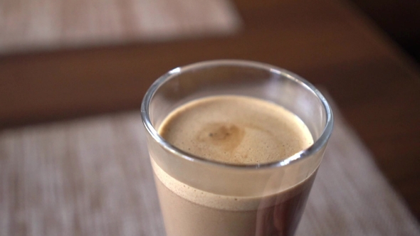 Pouring Cacao Into Glass Cup