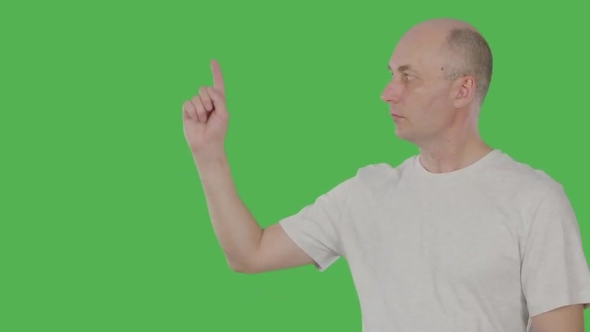 Caucasian Man Pointing Forefinger for Showing or Presenting Something Isolated on Green Background