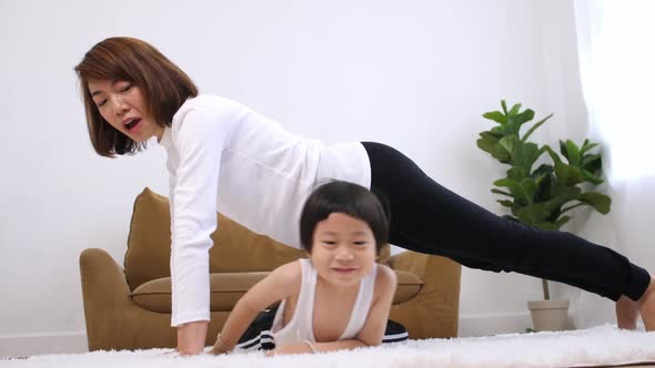 Young mother with her little son spending time together at home.