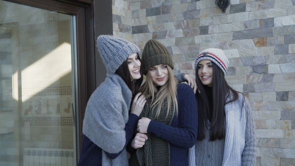 Three Pretty Girls in Caps and Scarf Posing on the Yard