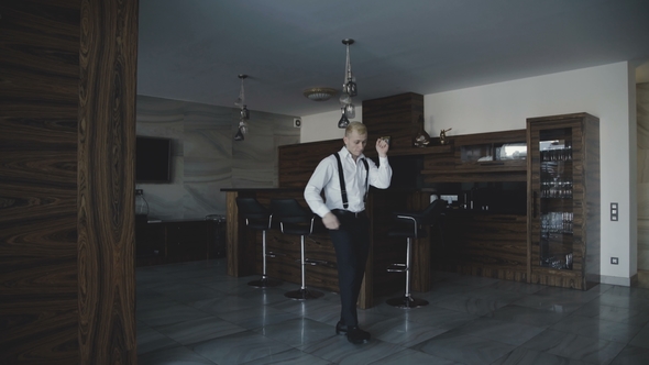 Glamorous Young Man in Stylish Suit Dancing in the Room