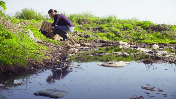 Ecologist Taking Samples of the Water