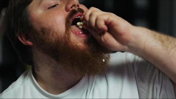 Fat Man Eats Pop-corn and Watches TV