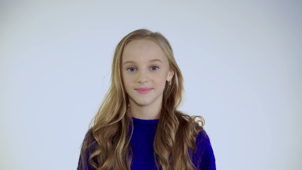 Portrait of Happy Girl with Bright Eyes and Smile Looking at Camera