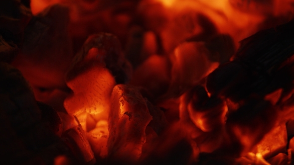 Fire Sparks Moving on Dark at Black Background Coming From Brightly Burning Warm alt