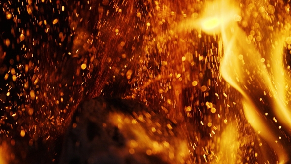 Fire Sparks Moving on Dark Black Background Coming from Brightly Burning Warm alt