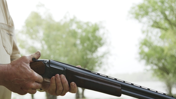 Man Makes a Shot From a Hunting Rifle