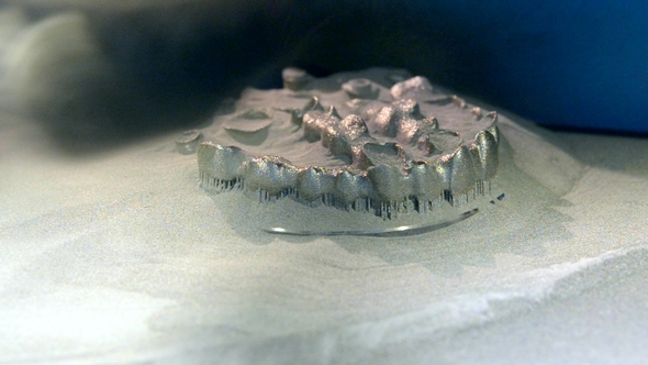 Man Is Cleaning with Brush Object Printed on 3d Metal Printer From Metal