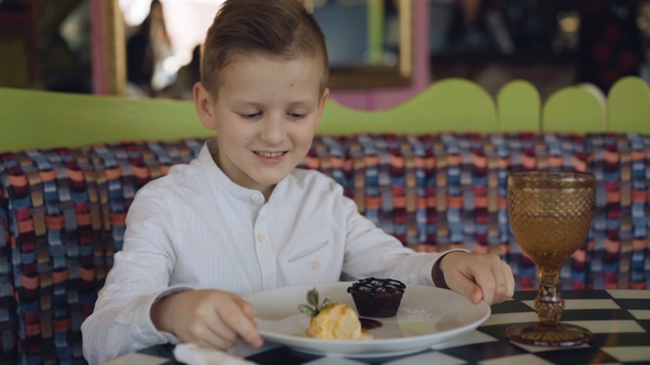 Handsome Boy Looking with Smile on Tasty Dessert Presentation.