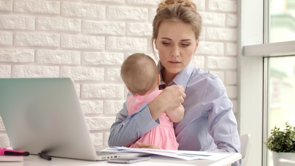 Business Mother Working From Home with Kid. Mother with Child Looking Documents