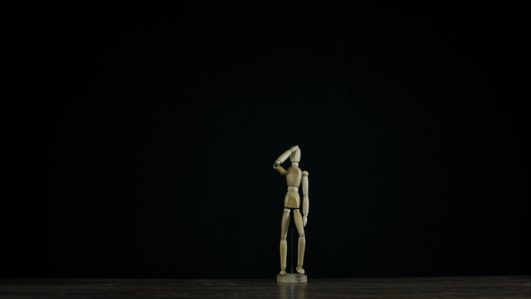 Stopmotion Wooden Figure Dummy in Studio on Black Background Marches