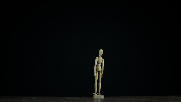 Wooden Figure Dummy in Studio on Black Background Stands and Rotates