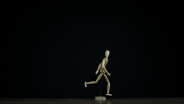  Running Wooden Figure Dummy Rotates in Studio on Black Background