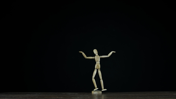 Wooden Figure Dummy in Studio on Black Background Rotates