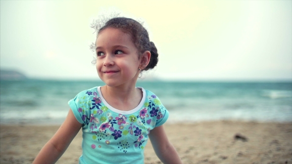 Little Girl on the Beach, Happy Little Baby Playing with Sand on the Beach. A Child, a Child