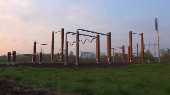 A Cameras Passes By a Outdoor Gym in a Quiet Neighborhood During Sunrise