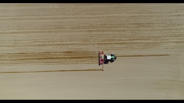 Aerial of Tractor on Harvest Field Ploughing Agricultural Field
