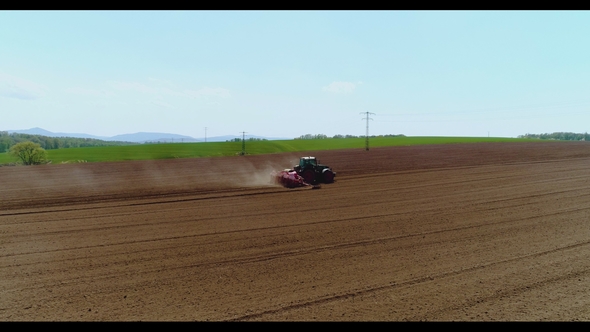 Tractor Working in Beautiful Spacious Agricultural Field