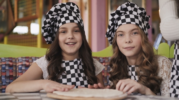 Portrait of Cheerful Girls in Uniform Cooking a Pizza and Having a Fun