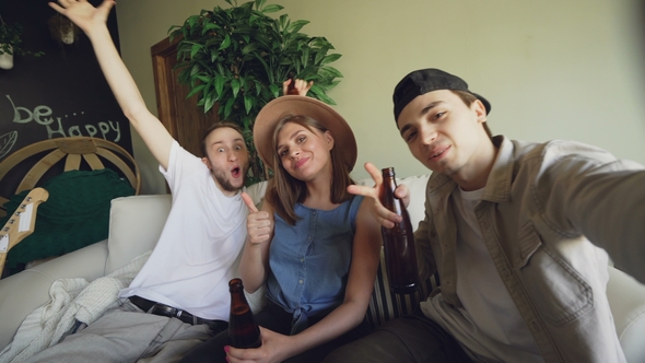 Point of View Shot of Cheerful Friends Taking Selfie with Beer Bottles, Posing and Smiling, Laughing