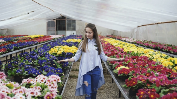 Happy Girl Walks, Choosing and Smelling Flower Seedling