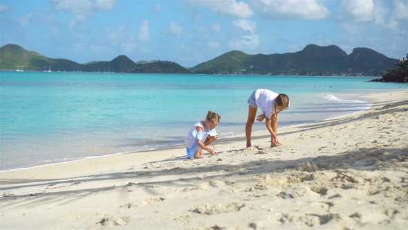 Two Kids Making Sand Castle and Playing at Tropical Beach