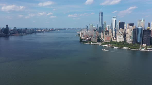 A bird's eye view over Upper Bay with a boat sailing by below. The drone truck right and dolly in to