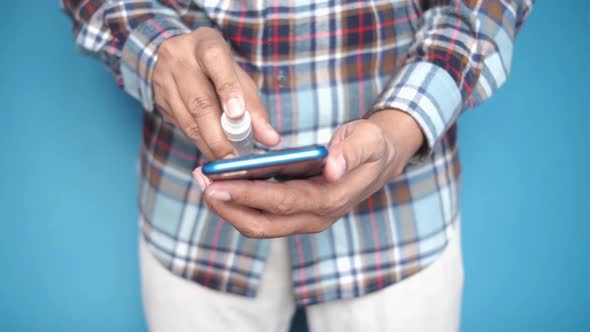 Cleaning Mobile Phone Display with Sanitizer Liquid