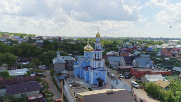 Orthodox Church with Golden Domes Under Cloudy Sky