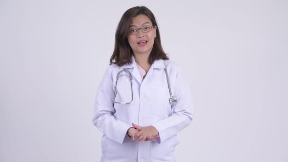 Happy Young Beautiful Asian Woman Doctor Explaining Something