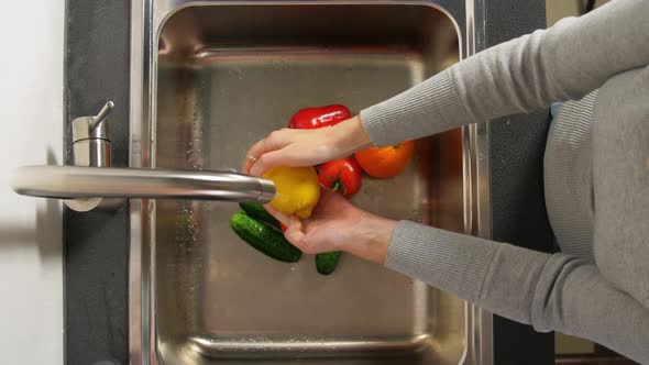 Woman Washing Fruits and Vegetables in Kitchen