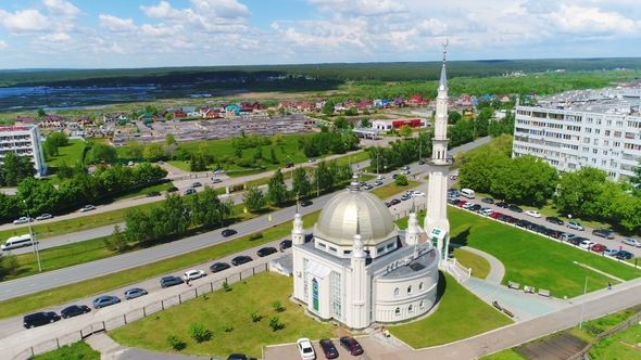 Temple with Moon on Tower Top Against Colorful Buildings alt