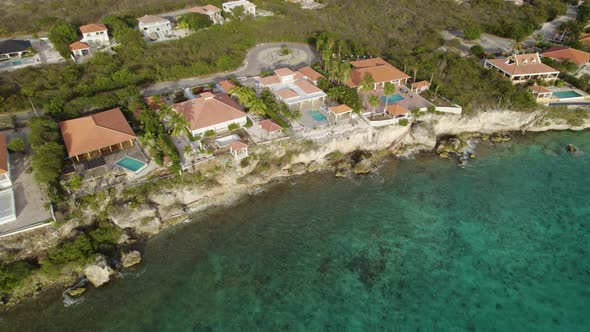 Aerial shot of the vacation houses on the shore of the tropical island