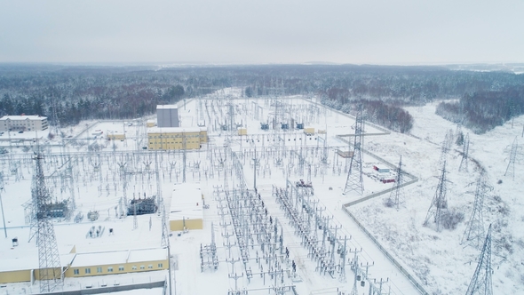 Electrical Transmission Station Among Snow and Woods