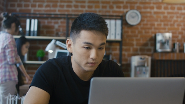 Confident Ethnic Man Using Computer