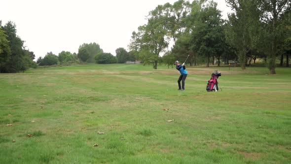Wide shot of a player hitting a clean fairway shot.