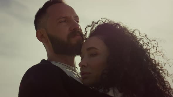 Multiethnic Lovers Hugging Outdoors at Sunset