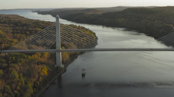 Cars driving across Penobscot Narrows Bridge autumn sunset AERIAL