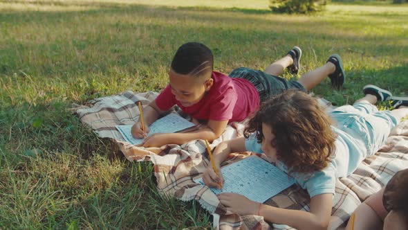 Multiethnic Diverse School Children Writing Examination Test Outdoors