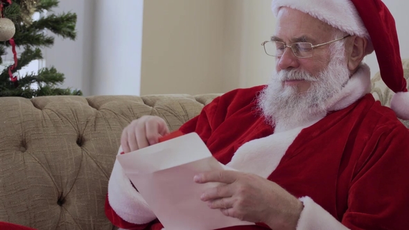 Santa Opens the Envelope and Begins To Read the Christmas Letter