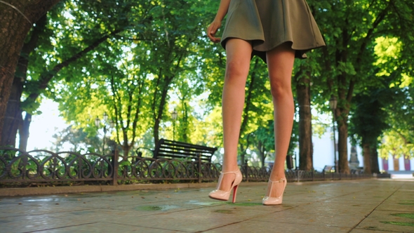 Sexy Legs with High Beige Heels Walking in Park of City. Woman Walking on Boulvard Alone. Attractive