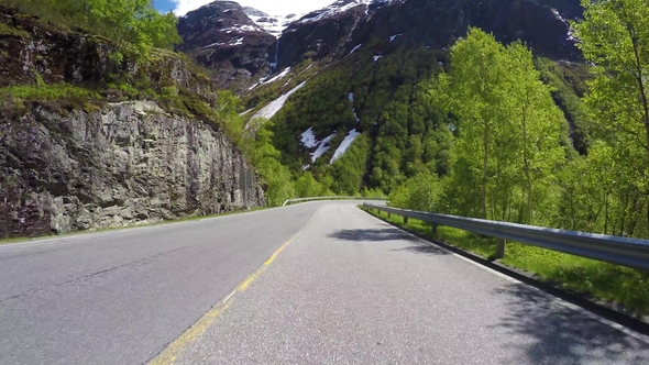 Driving a Car on a Serpentine Road in Norway