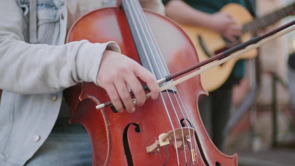 Unrecognizable Man Playing Cello Outside