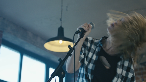 Emotional Girl Singing Into Microphone