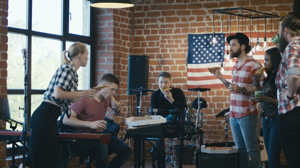 Musicians Having Pizza During Rehearsal