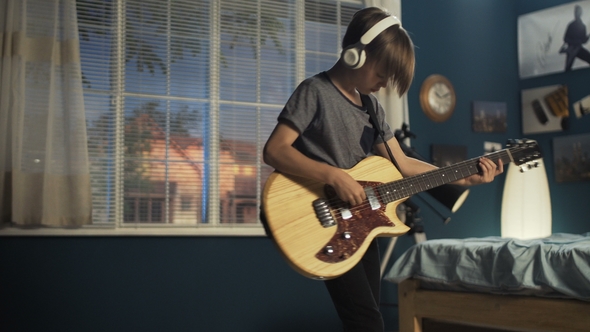 Youngster with Guitar in Bedroom