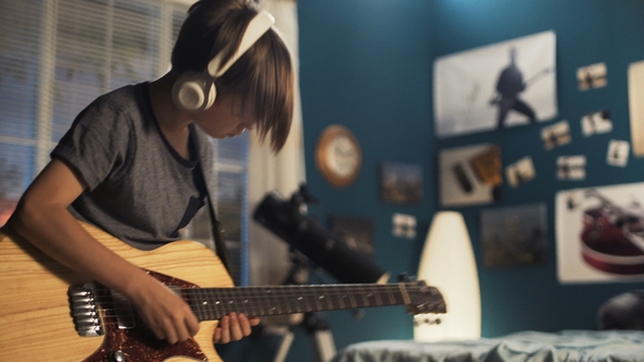 Youngster with Guitar in Bedroom